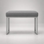 Bencivola Pedicure Footrest, detailed with rectangular end supports and a grey stitched cushion against a grey backdrop.