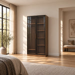 Bestylora Glass Storage Cabinet combines dark-framed reeded glass with visible interior shelves in a furnished bedroom.