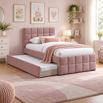 Cemaliso Dusty Pink Kids Trundle Bed featuring dusty pink upholstery alongside white bedding against a bedroom wall.