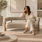Close-up of Comolara Beige Bouclé Upholstered Bench, highlighting curved backrest with its construction clearly visible.