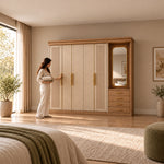 Dolbarino 5 Door Wooden Wardrobe with Vanity with a woman standing beside the cabinet; fluted doors and an adjoining mirror.