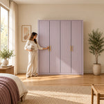 Elegitora Lavender 4 Door Fluted Wardrobe with four lavender fluted doors, beside a woman reaching toward the door.
