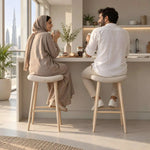 Close-up of Fikomira Curved Upholstered Counter Stool, highlighting curved padded seat for a modern dining room interior.