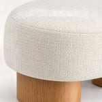 Close-up of Flussora Beige Upholstered Curved Bench, highlighting flowing organic shape for a modern entryway interior.