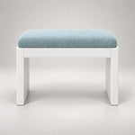 Harteslo Pedicure Footrest against a grey backdrop: a pale blue cushion, a rounded padded top and straight end supports.