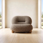 Jimkana Upholstered Accent Chair product view showing deep cushioned seat and rounded backrest in a modern home setting.