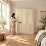 Kapilosa 3 Door Wooden Wardrobe, arched panel detailing and three cream doors, with a woman standing beside the cabinet.