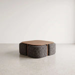 Makina Wooden Coffee Table with Ottomans featuring rounded tabletop and four compact ottomans in a clear product photograph.