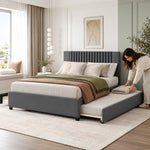 Morubby Charcoal Grey Kids Trundle Bed with a woman arranging the extended underbed, featuring a plain padded footboard.