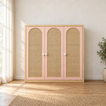 Natupiny 3 Door Rattan Cane Wardrobe: a natural wood border, blush-pink framing and woven door inserts in a sunlit bedroom.