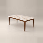 Olzenro Marble Top 6-Seater Dining Table, with tapered walnut-brown legs and a warm wooden apron against a grey backdrop.
