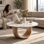 Alternate view of Ottavino White Marble Coffee Table, showing round top and curved wood base in a balanced home interior.