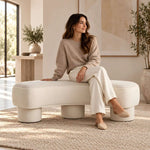 Close-up of Pietovy Cream Curved Upholstered Bench, highlighting flowing curved form for room layout and styling ideas.