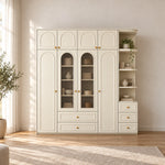 Rakilony 4 Door Wardrobe with Side Shelves in a sunlit bedroom, showing lower storage drawers alongside upper cupboards.