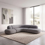 Romensia Grey Curved 5-Seater Sofa featuring curved sectional design and deep cushioned seats in a clear product photograph.