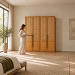 Segustona 4 Door Wooden Wardrobe with a woman standing beside the cabinet; a warm wood finish and four cane-front doors.