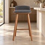 Sheftona Wooden Counter Stool featuring padded seat and backrest in a clear product photograph in a modern home setting.
