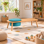 Stepsoly Kids Wooden Floor Table with Pouf pairs a round teal pouf with four splayed wood legs beside a playroom window.