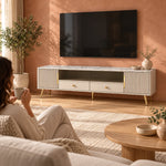 Vendrilosa White Marble Top TV Unit with a woman beside the living room media wall, showing dark glass centre doors.