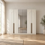 Weltwiyo 6 Door Wooden Wardrobe displays pale full-height doors together with a broad wardrobe frame in a furnished bedroom.