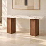 Yorkosta marble console table with pale veined top and two brown wood block supports in a clean studio product photo.