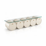Zoverina Cream Glass Top TV Unit with cream cylindrical sections and five circular storage fronts on a white background.