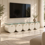 Zoverina Cream Glass Top TV Unit pairs small gold-tone knobs with cream cylindrical sections beside living room seating.