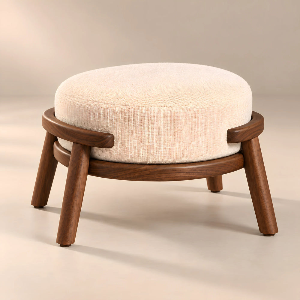 Trikovota Beige Round Pouf featuring round upholstered cushion and curved exterior rails in a clear product photograph.