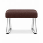 Anoltina Pedicure Footrest in brown leather with a thick curved cushion and polished metal legs forming angled sled supports.