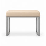 Cream beige leather upholstery tops the Bencivola Pedicure Footrest, above stitched cushion edges and a slim metal frame.