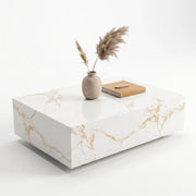 Lumi Solid Surface Gold White Coffee Table with a sleek solid surface finish featuring gold veining, styled with a minimalist beige vase and a closed book on top.