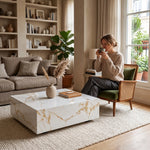 Lumi Solid Surface Gold White Coffee Table with a sleek marble-like finish in a modern living room setting featuring neutral tones and natural light.