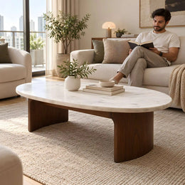 Alternate view of Isshomina White Marble Coffee Table, showing rounded oval top, smooth curved edges, and panel-style legs.