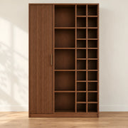 Kokovera wooden bookshelf in brown finish with open shelves, varied cubbies, and a tall vertically fluted closed section.