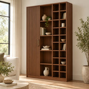 Kokovera wooden bookshelf with asymmetrical open compartments and a fluted cabinet panel for concealed storage space.