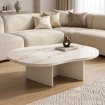 Cloud Curve Solid Surface Gold Coffee Table with a smooth, curved solid surface top featuring subtle gold veining, supported by a modern, minimalist base in a neutral living room setting.