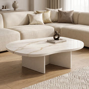 Cloud Curve Solid Surface Gold Coffee Table with a smooth, curved solid surface top featuring subtle gold veining, supported by a modern, minimalist base in a neutral living room setting.
