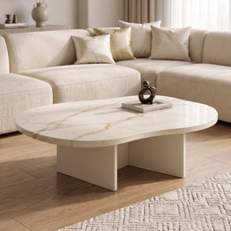 Cloud Curve Solid Surface Ivory Coffee Table with smooth curved edges and ivory marble-like surface, placed in a modern living room with neutral-toned sectional sofa and wooden flooring.