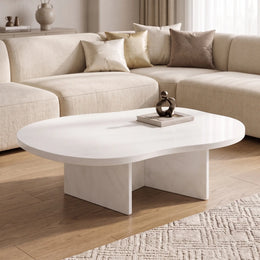Cloud Curve Solid Surface White Coffee Table with a smooth curved top and sturdy base, placed in a modern living room with neutral tones and soft lighting.