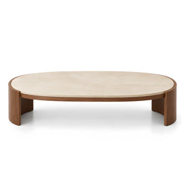 Alternate view of Unkano Travertine Oval Coffee Table, showing elongated oval top and curved base in a modern home setting.