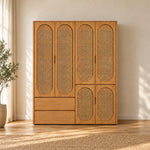 Alvarario 4 Door Wooden Cane Wardrobe displays a warm wood finish together with a lower drawer section in a sunlit bedroom.