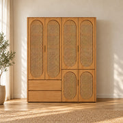 Alvarario 4 Door Wooden Cane Wardrobe displays a warm wood finish together with a lower drawer section in a sunlit bedroom.