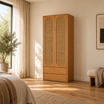 Alvarario 2 Door Wooden Cane Wardrobe with Drawer, detailed with two tall cane-panel doors beside a bedroom window.