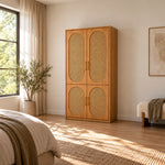 Alvarario 2 Door Wooden Cane Wardrobe featuring a narrow wooden case alongside a warm wood finish in a furnished bedroom.