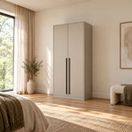 Balomora 2 Door Wooden Wardrobe displays long black handles together with a neutral outer case beside a bedroom window.
