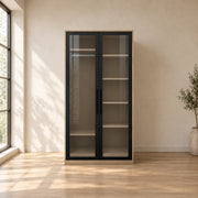 Balomora 2 Door Transparent Glass Cabinet Storage with smoked-glass panels and a neutral outer case in a sunlit bedroom.