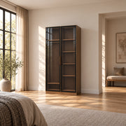 Bestylora Glass Storage Cabinet combines dark-framed reeded glass with visible interior shelves in a furnished bedroom.