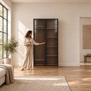 Bestylora Glass Storage Cabinet beside a woman reaching toward the door; slim vertical handles and two full-height doors.