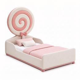 Alternate view of Bubblie Candy Pink Kids Toddler Bed, showing candy-inspired spiral headboard, bow detail, and padded sides.