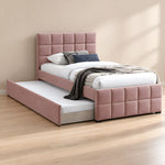 Cemaliso Dusty Pink Kids Trundle Bed displays dusty pink upholstery together with white bedding beside a bedroom window.
